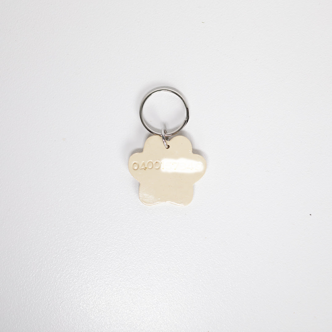 Paw print pet tag with phone number